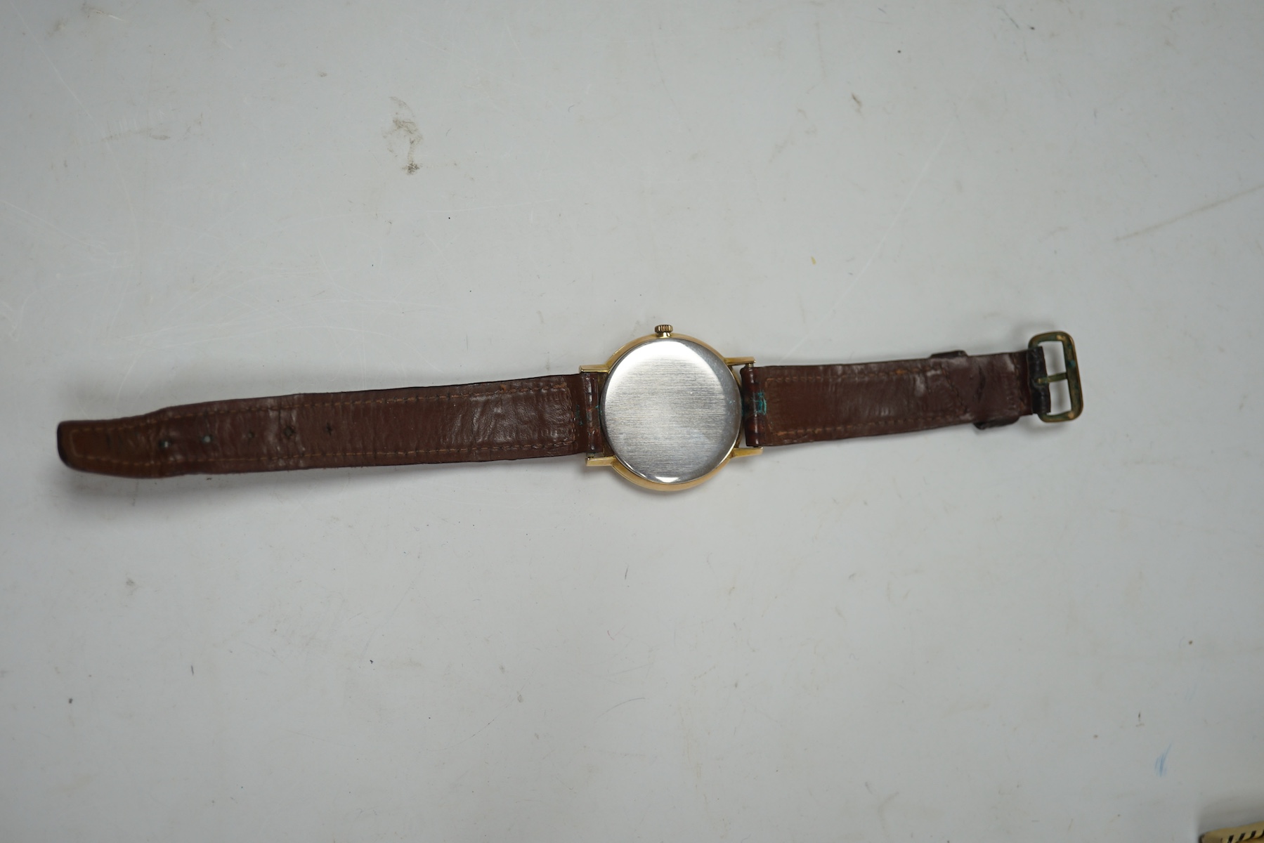 A gentleman's gold plated Omega manual wind wrist watch, on a leather strap, case diameter 34mm. Condition - Fair